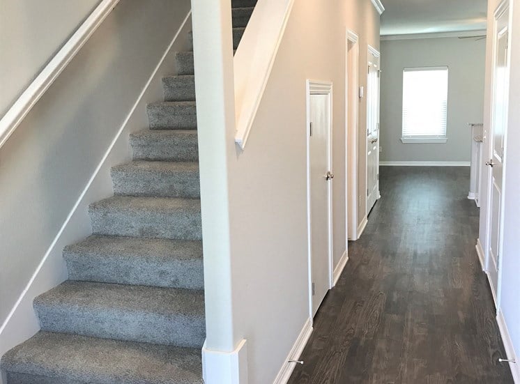 C1 (1-car) Entry with laminate wood flooring and staircase